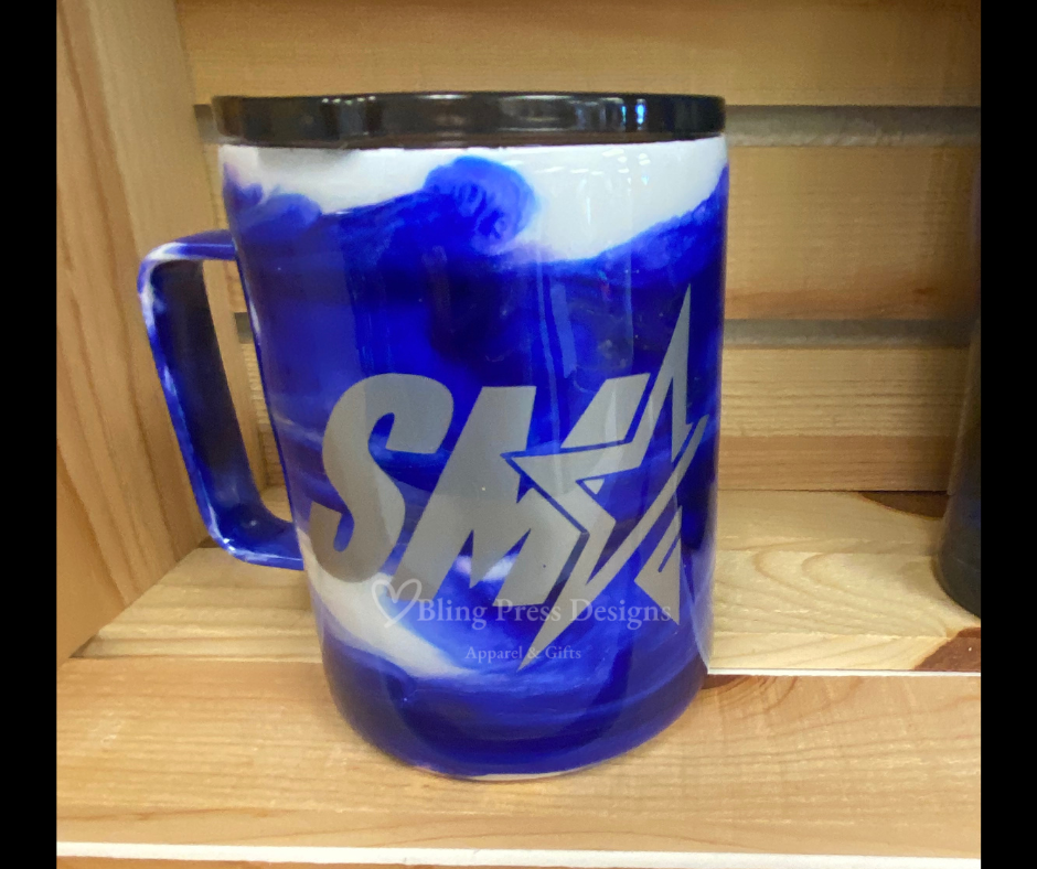 A **SMA Swirl Epoxied Coffee Mug ** featuring a vibrant swirl design and the **SMA** logo, finished with a smooth epoxy coating for durability and shine. Perfect for keeping drinks at the ideal temperature while showcasing school pride.