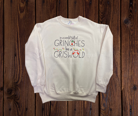 Sand-colored sweatshirt with the festive saying “In a world full of Grinches, be a Griswold” printed on the front.