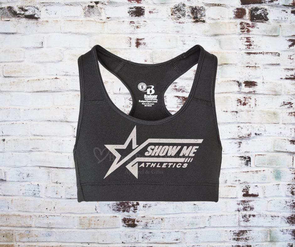 A black Razorback sports bra with a glitter "Show Me Athletics" logo, crafted from moisture-wicking, stretchy fabric for comfort and support.
