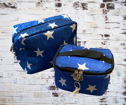 Blue glitter glam bag with sparkling stars scattered across the surface, creating a shimmering and festive look. Handle and non handled bags are featured.