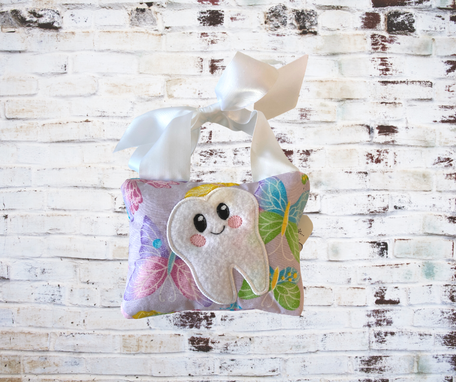 A **Handmade Fabric Tooth Fairy Pillow**, featuring a small pocket for placing lost teeth, crafted from soft, high-quality fabric with charming details. A functional and magical keepsake for children.