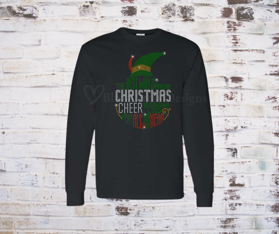 A festive black long sleeve T-shirt featuring a sparkling rhinestone design of a cheerful Christmas elf, accented with holiday-themed details. The bling embellishments catch the light, adding a glamorous touch to the holiday spirit.