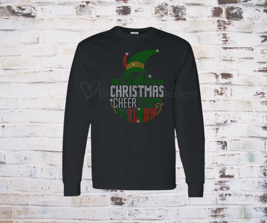 A festive black long sleeve T-shirt featuring a sparkling rhinestone design of a cheerful Christmas elf, accented with holiday-themed details. The bling embellishments catch the light, adding a glamorous touch to the holiday spirit.