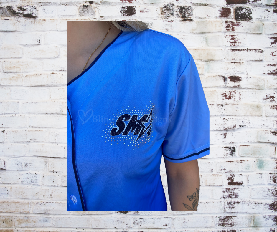 A Close up Front view of the Show Me Rhinestone Jersey featuring a glitter vinyl logo and rhinestone accents, combining sporty style with a sparkling design.