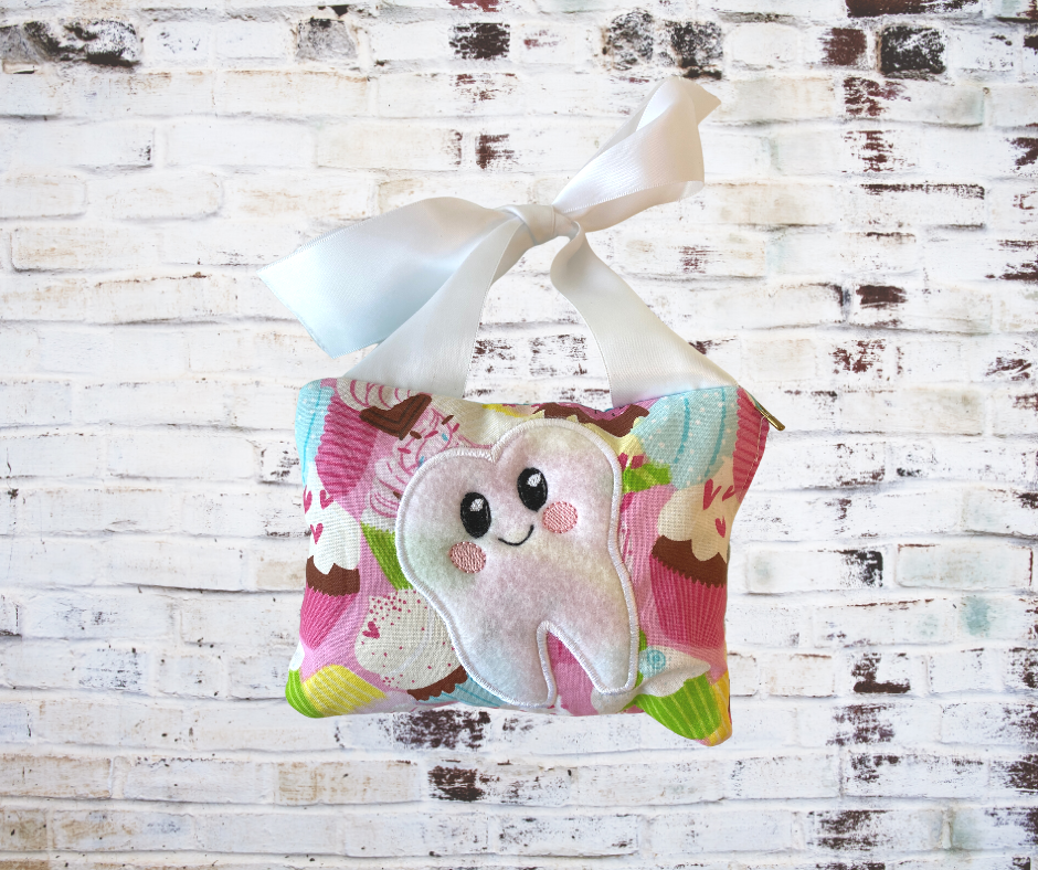 A **Handmade Fabric Tooth Fairy Pillow**, featuring a small pocket for placing lost teeth, crafted from soft, high-quality fabric with charming details. A functional and magical keepsake for children.