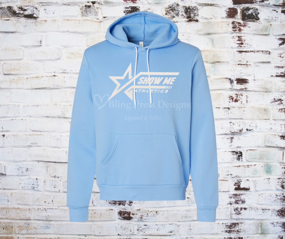 A carolina blue soft and cozy hoodie featuring a white glitter "Show Me" logo, designed with a relaxed fit, front pocket, and adjustable drawstring hood.