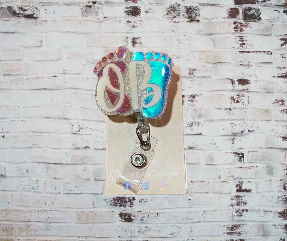 A handmade glitter badge reel with an interchangeable top, featuring a retractable cord and secure clip, perfect for adding sparkle and personality to work attire.
