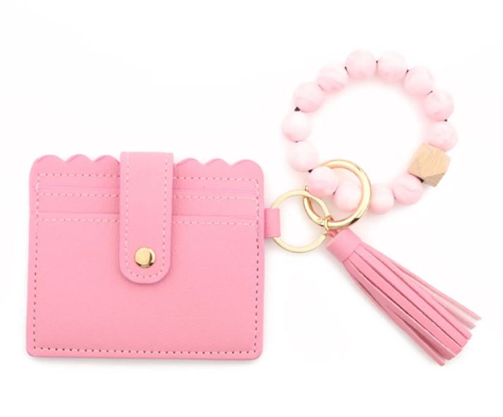 A pink stylish silicone beaded wristlet with soft, flexible beads on a durable elastic cord, designed for comfortable wear and hands-free key or accessory carrying.