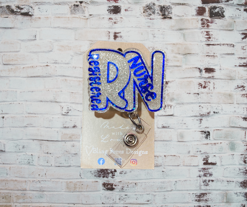 A handmade glitter badge reel with an interchangeable top, featuring a retractable cord and secure clip, perfect for adding sparkle and personality to work attire.