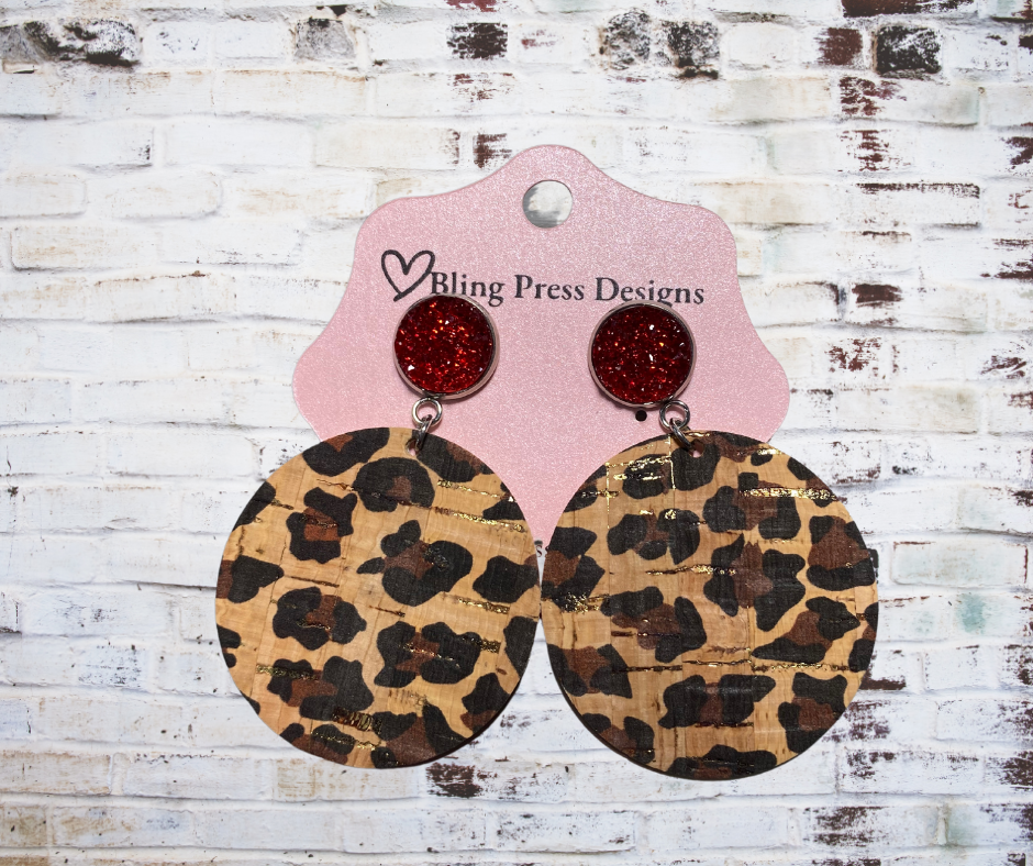 Cork leopard print dangle earrings with red sparkling druzy accents, featuring a lightweight and stylish design.