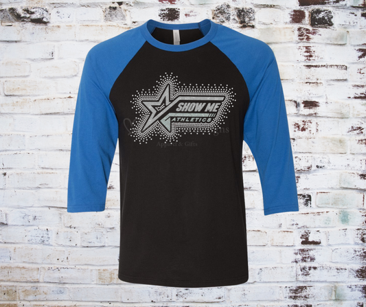 A rhinestones surrounding Show Me Athletics logo on a contrast colored 3/4 sleeve raglan tee, showcasing a comfortable fit with a touch of sparkle
