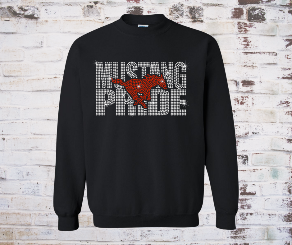 Sweatshirt featuring a sparkling rhinestone design of a galloping mustang with the words “Mustang Pride.” The rhinestones shimmer in the light, creating a bold and spirited look perfect for showing team pride.