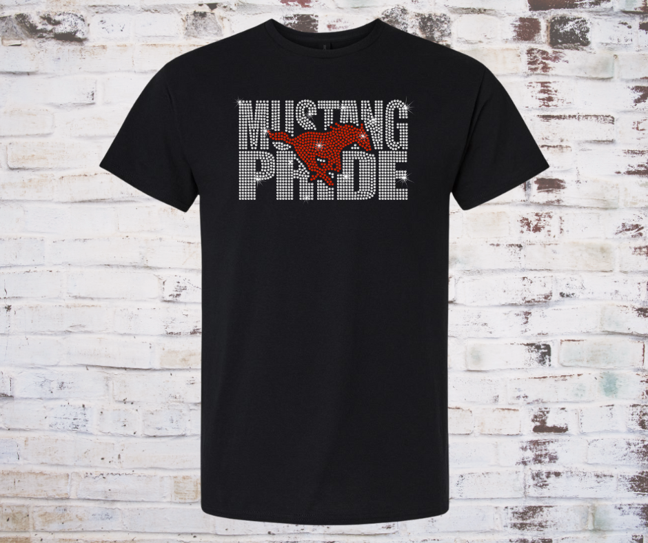 Tee Shirt featuring a sparkling rhinestone design of a galloping mustang with the words “Mustang Pride.” The rhinestones shimmer in the light, creating a bold and spirited look perfect for showing team pride.