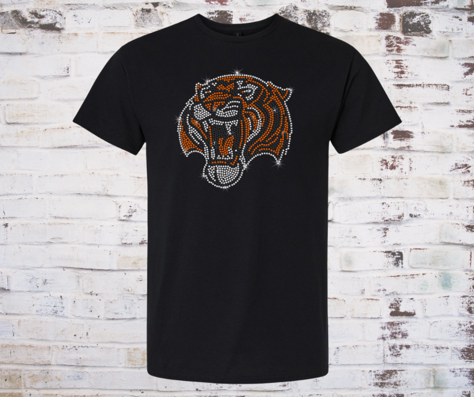 Black t-shirt with a rhinestone tiger logo design on a wooden background