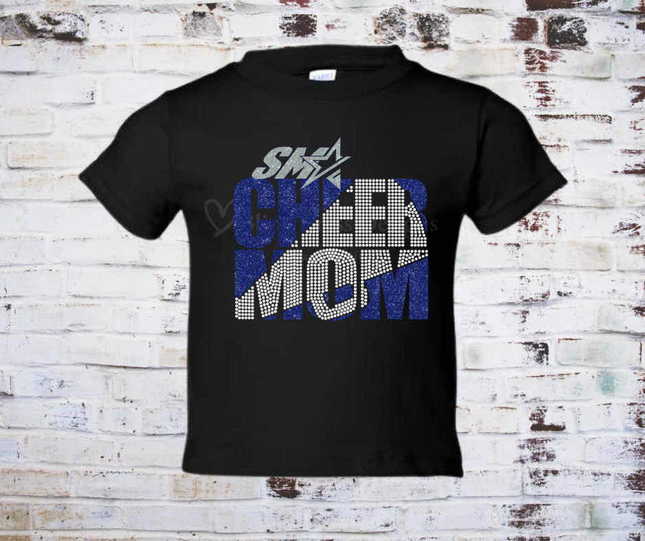 A Rhinestone and Glitter Vinyl Cheer Mom Tee, featuring a sparkling Cheer Mom design with glitter vinyl and rhinestone accents. Made from soft, breathable fabric for a stylish and comfortable look at cheer events or everyday wear.