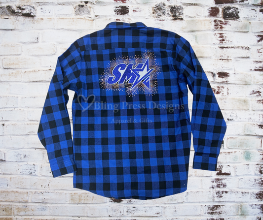 A SMA Flannel Long Sleeve Shirt featuring a glitter vinyl SMA logo and a sparkling rhinestone spray design. Made from soft, high-quality flannel for a stylish and comfortable look, perfect for layering and showcasing school spirit.