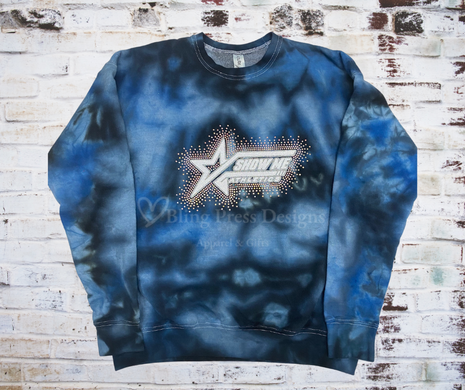 A Tie Dye Sweatshirt featuring a glitter Show Me Athletics logo with a scatter of rhinestones, adding sparkle and shimmer.