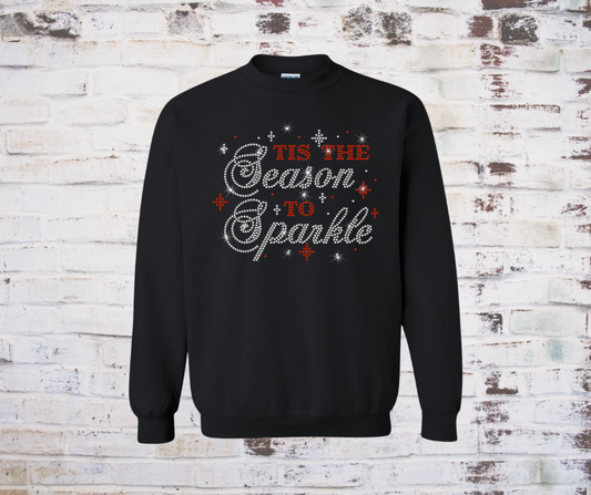 Holiday sweatshirt featuring a rhinestone design that reads “Tis the Season to Sparkle” in shimmering festive lettering.