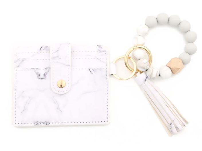 A white marbled stylish silicone beaded wristlet with soft, flexible beads on a durable elastic cord, designed for comfortable wear and hands-free key or accessory carrying.