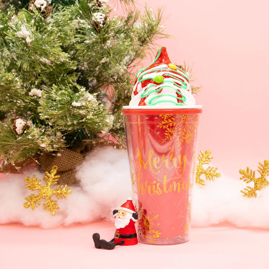 A festive Christmas tumbler featuring holiday-themed designs, perfect for sipping seasonal drinks. It includes a secure lid and straw, ideal for on-the-go enjoyment during the holiday season.