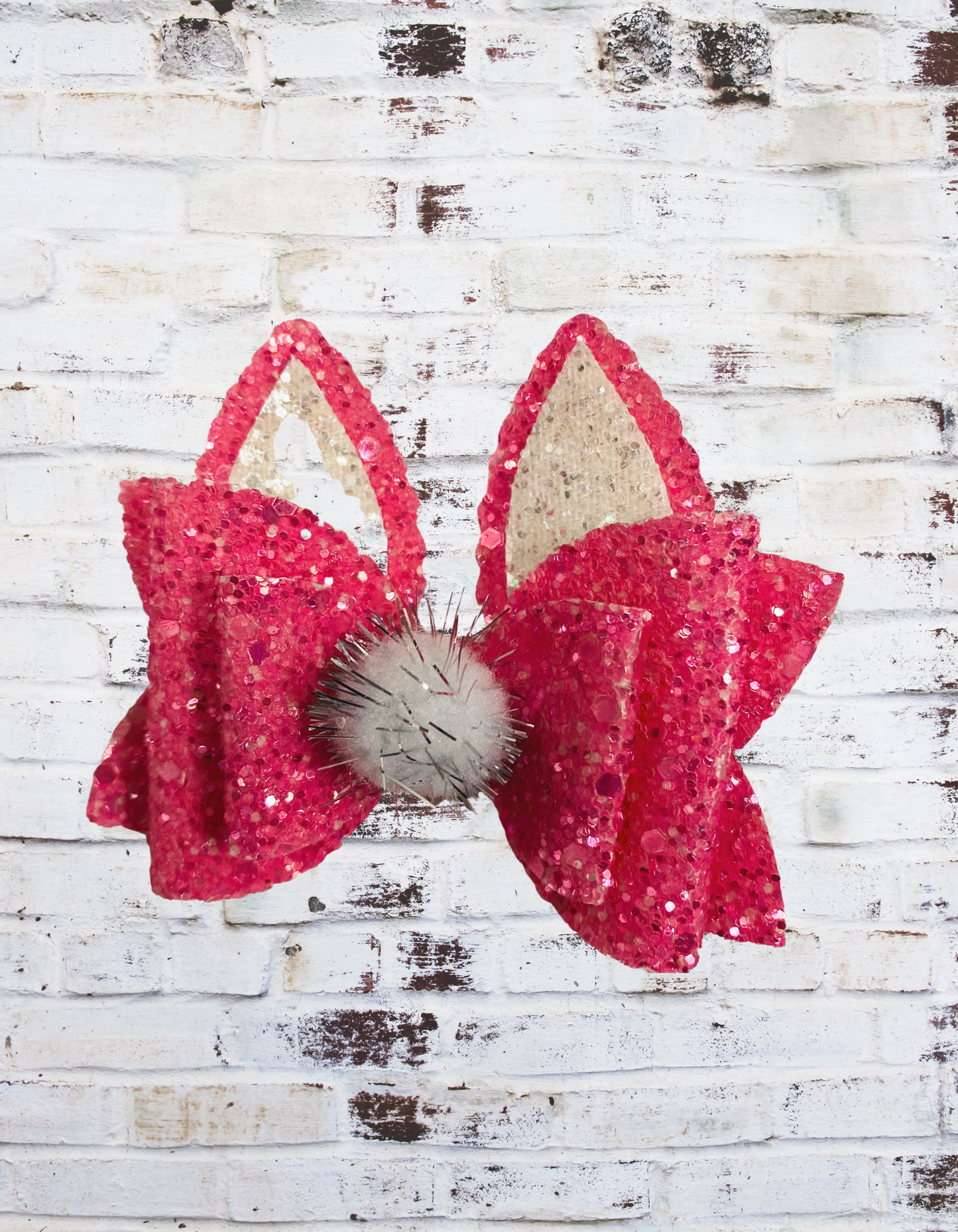 A dark pink glitter bunny hair bow with a sparkling finish, securely attached to a clip or band, perfect for Easter outfits and festive hairstyles.