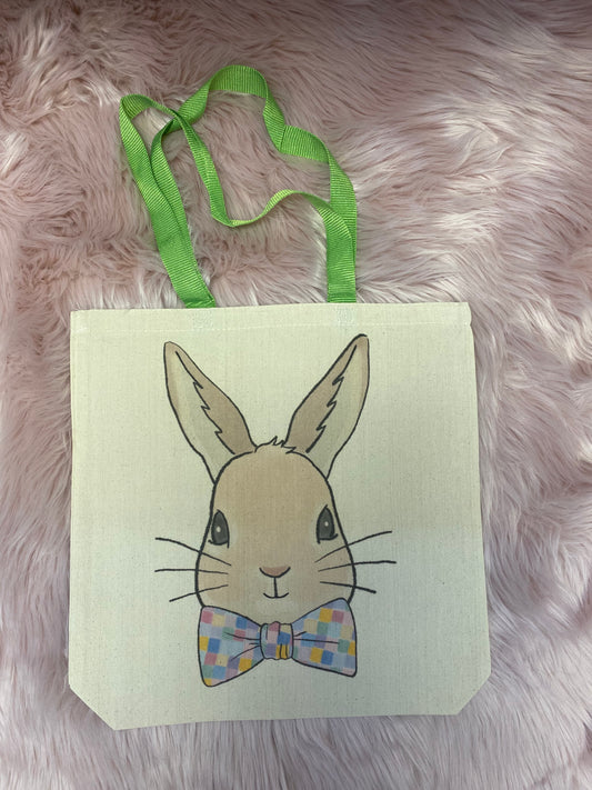 A canvas tote bag featuring a cute Easter Bunny with a bow tie, made from durable, eco-friendly material, perfect for carrying Easter gifts, eggs, and everyday essentials.