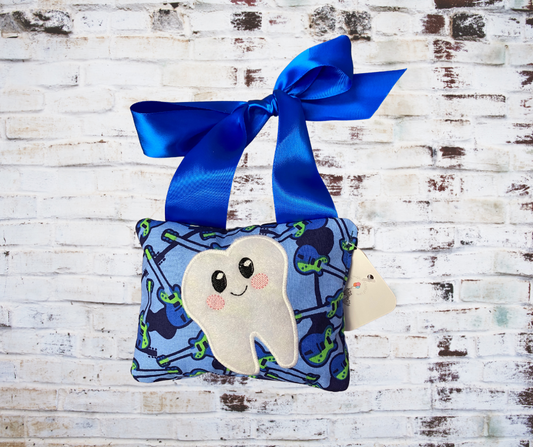 A **Handmade Fabric Tooth Fairy Pillow**, featuring a small pocket for placing lost teeth, crafted from soft, high-quality fabric with charming details. A functional and magical keepsake for children.