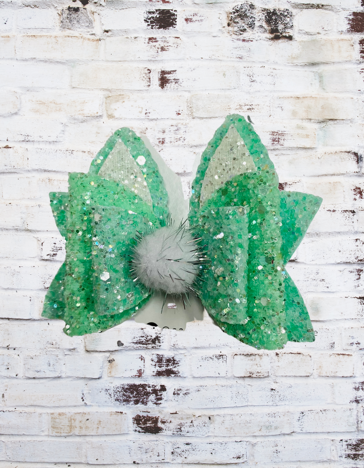 A mint glitter bunny hair bow with a sparkling finish, securely attached to an aligator clip, perfect for Easter outfits and festive hairstyles