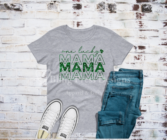 A "One Lucky Mama" tee with bold glitter vinyl lettering on soft, comfortable fabric. The sparkling design adds a fun and eye-catching touch, perfect for proud moms to show off their lucky and loving spirit.