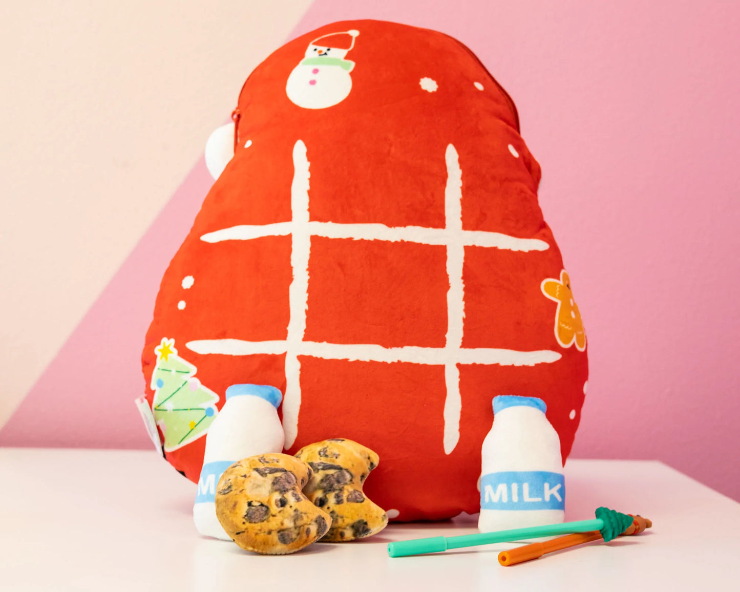 A Back view of Santa Mini Plushie , featuring a tic tac toe board and mini plushies shaped like milk and cookies. Perfect for cuddling or adding festive charm to your holiday decor.