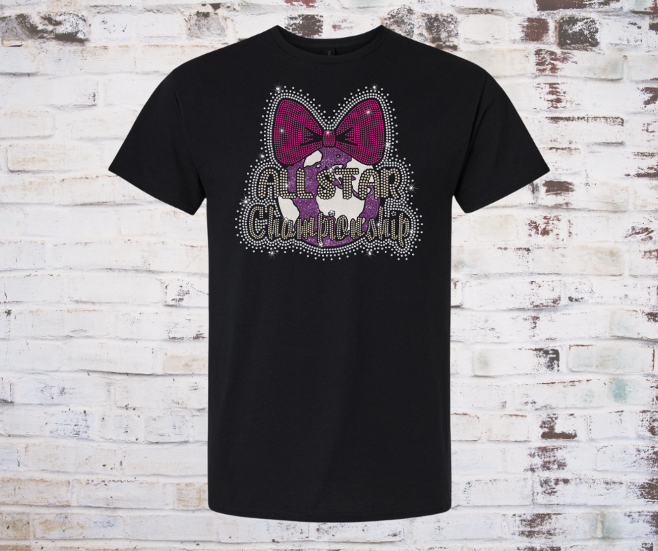 Black T-shirt featuring a rhinestone “All Star World Championship” design with a pink cheer bow and sparkling accents on the front.