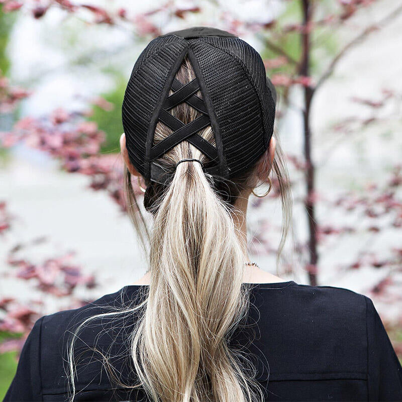 The back view of a distressed criss cross ponytail hat with a breathable design, adjustable Velcro strap, and elastic back openings for high, mid, or low ponytails, perfect for casual wear and customization.