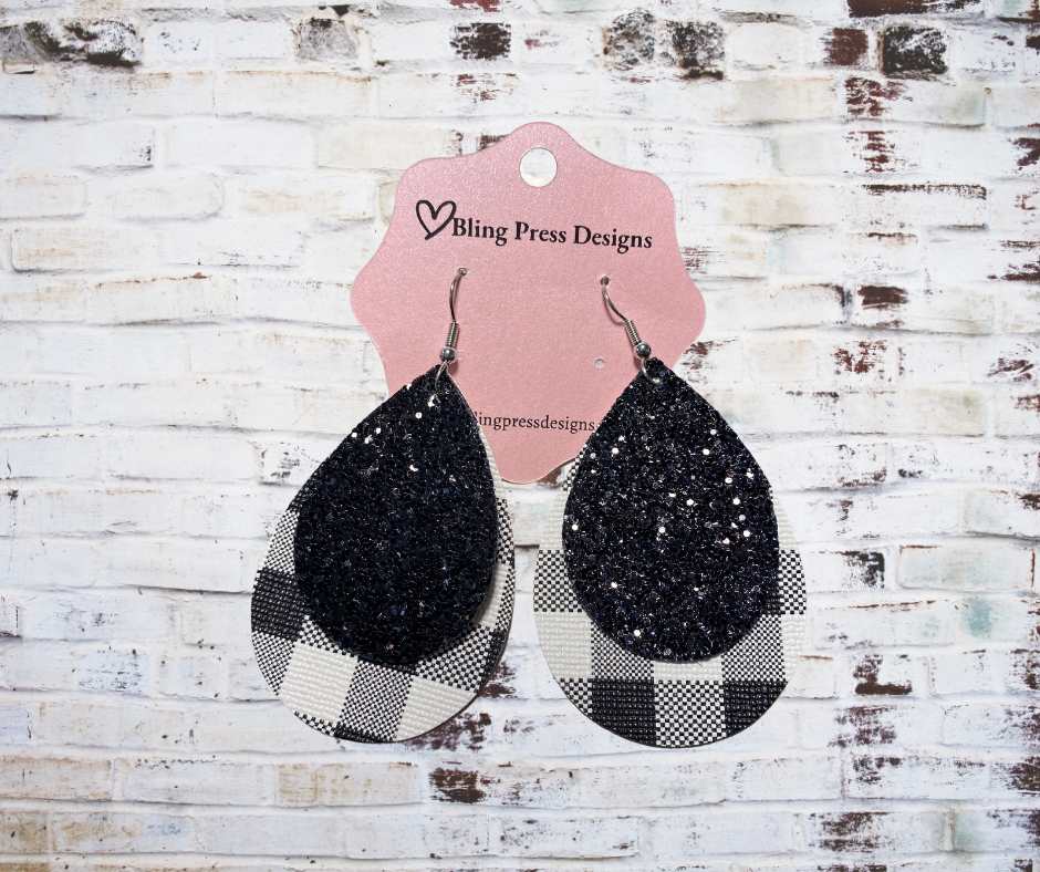 Black glitter and Black plaid pattern faux leather dangle earrings, 2.5 inches in length, with lightweight design and nickel-free, hypoallergenic backs.