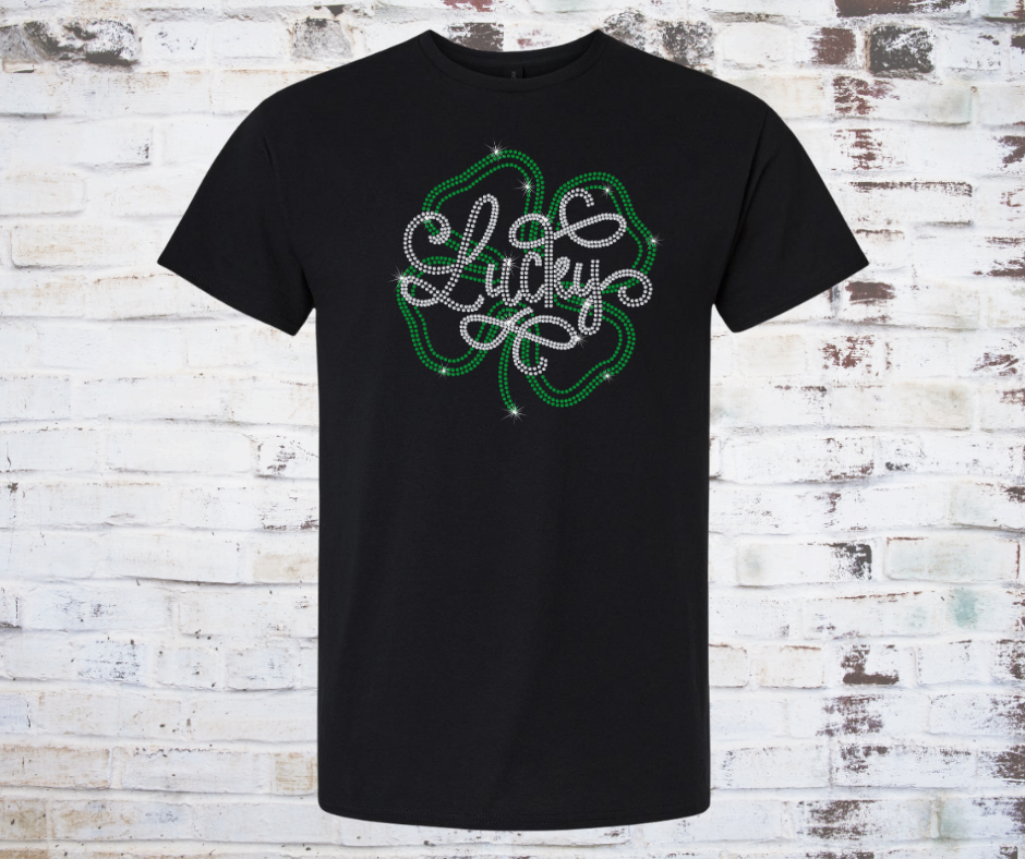 Black t-shirt with rhinestone lucky shamrock design on a wooden background