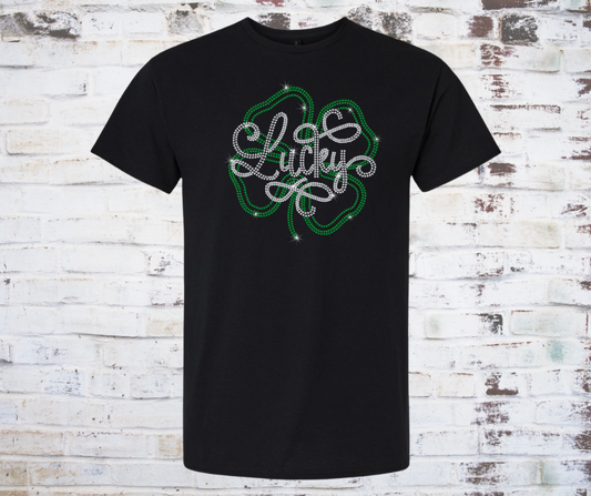 Black t-shirt with rhinestone lucky shamrock design on a wooden background