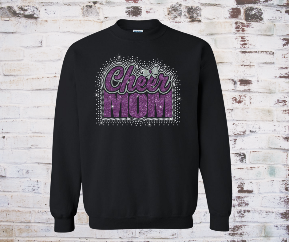 Black sweatshirt with a glitter and rhinestone design that reads ‘Cheer Mom’ accented with a bow with a rhinestone scatter around it