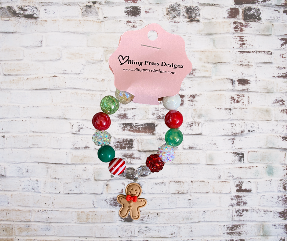 Colorful kids holiday stretch bracelets made with large bubble gum beads and festive charms, including Christmas-themed designs.
