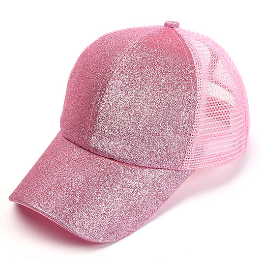  A pink glitter finish ponytail hat with a crisscross elastic back, adjustable Velcro strap, and lightweight design, ideal for ponytails, customization, or adding sparkle to casual wear.