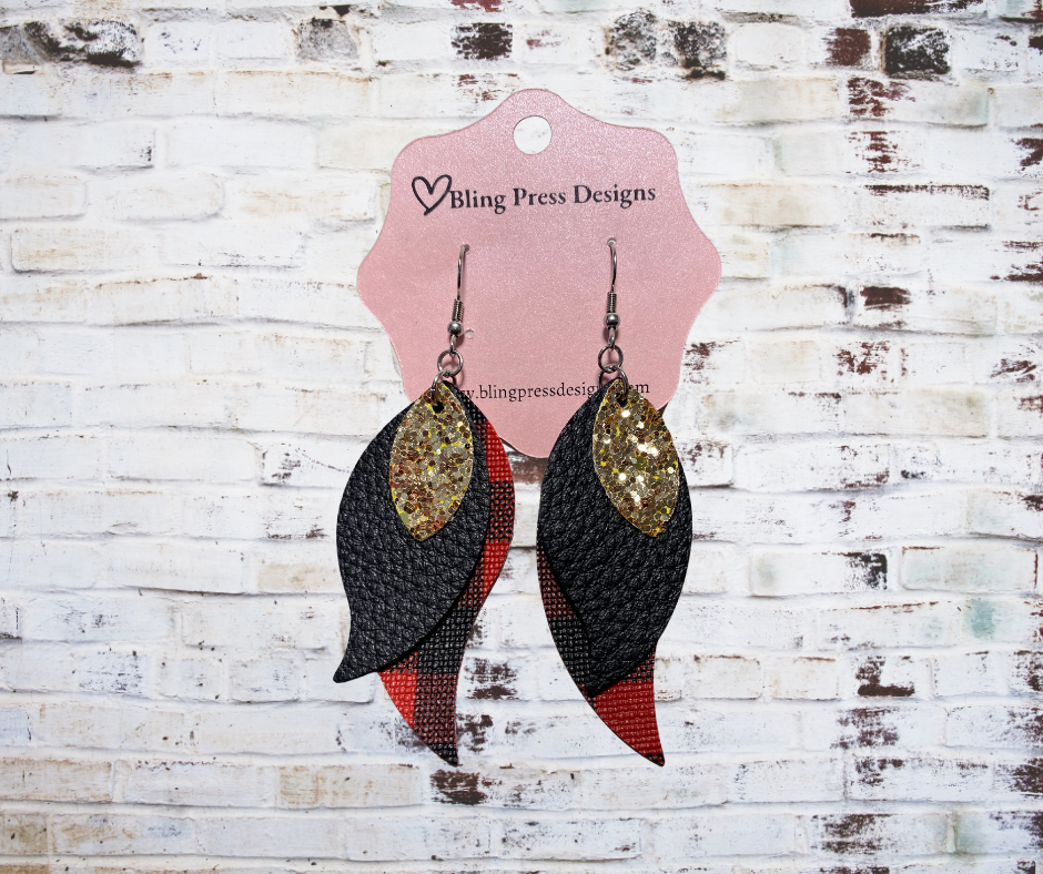 Petal shaped Faux leather stacked gold glitter and red plaid dangle earrings, featuring layered faux leather with a shimmering gold glitter finish and a contrasting plaid pattern.