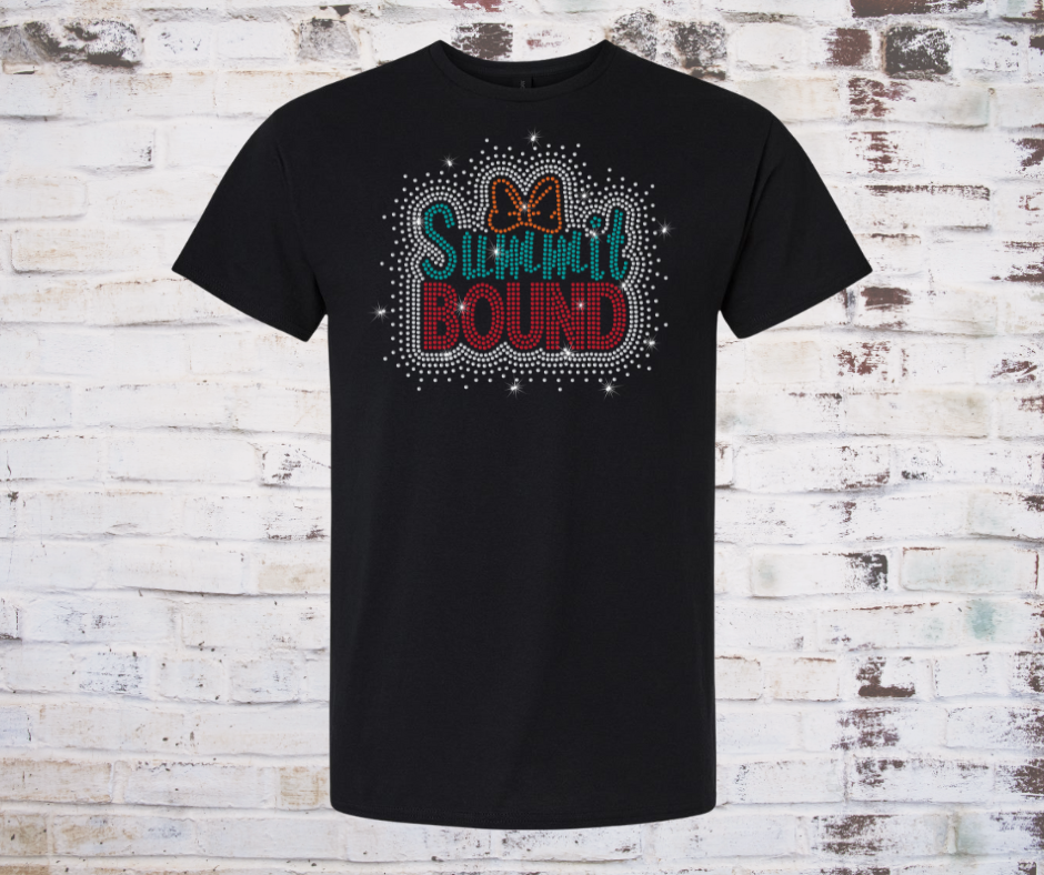 Black t-shirt with 'SUMMit BOUND' rhinestone text and bow design on a rustic wooden background