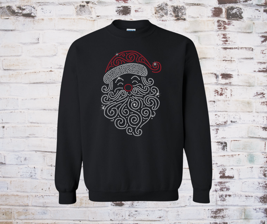Black sweatshirt with Santa Claus design on a textured white brick wall background