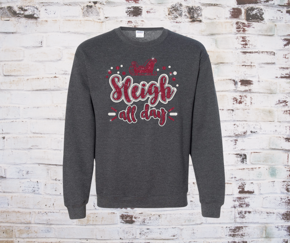 Gray sweatshirt with 'Will Sleigh All Day' text on a brick wall background