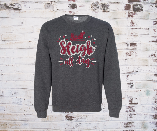Gray sweatshirt with 'Will Sleigh All Day' text on a brick wall background