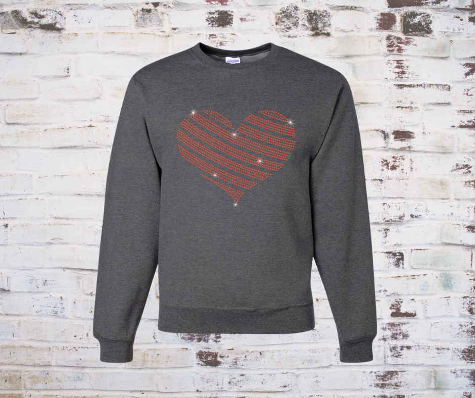 Gray sweatshirt with a red rhinestone heart design on a rustic wooden background