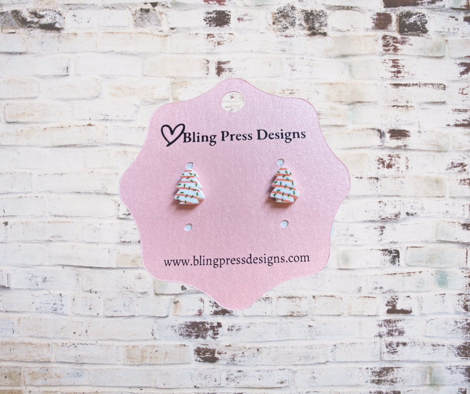 Small Christmas tree cake stud earrings featuring a festive green tree design with holiday details.
