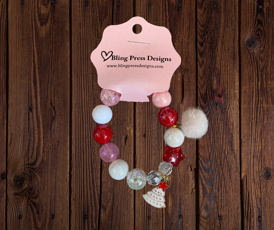 Colorful kids holiday stretch bracelets made with large bubble gum beads and festive charms, including Christmas-themed designs.
