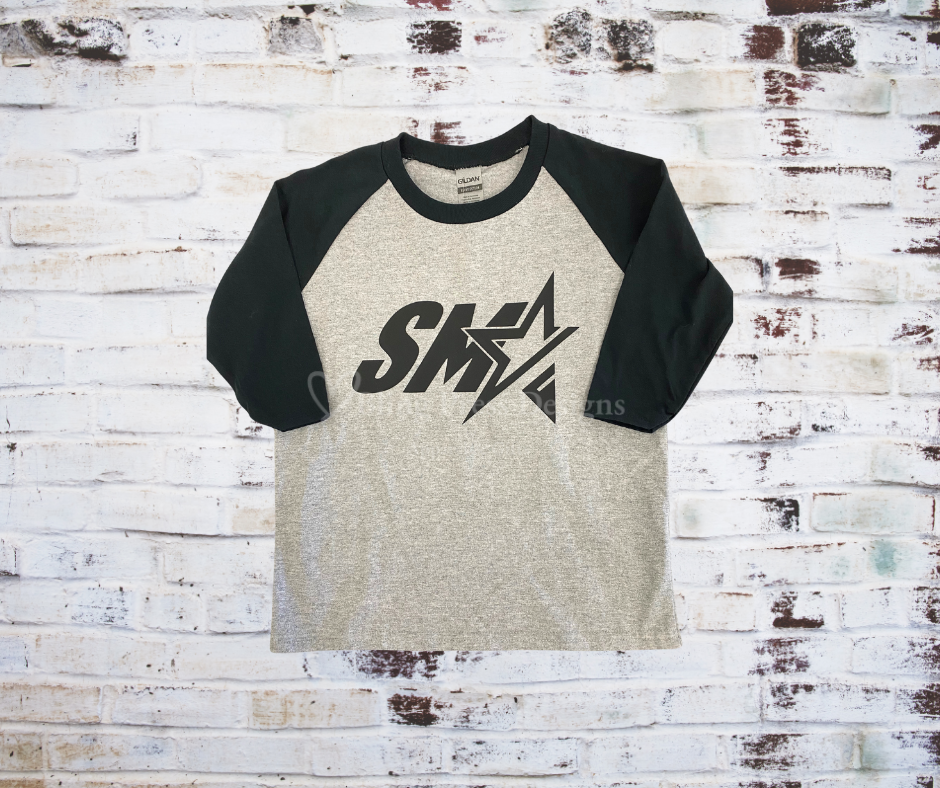 A grey SMA Logo 3/4 Sleeve Raglan Tee, featuring the bold SMA logo with black contrasting 3/4 sleeves for a sporty, stylish look. 