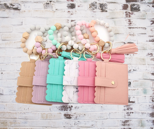 Collection of  stylish silicone beaded wristlet in various colors with soft, flexible beads on a durable elastic cord, designed for comfortable wear and hands-free key or accessory carrying.