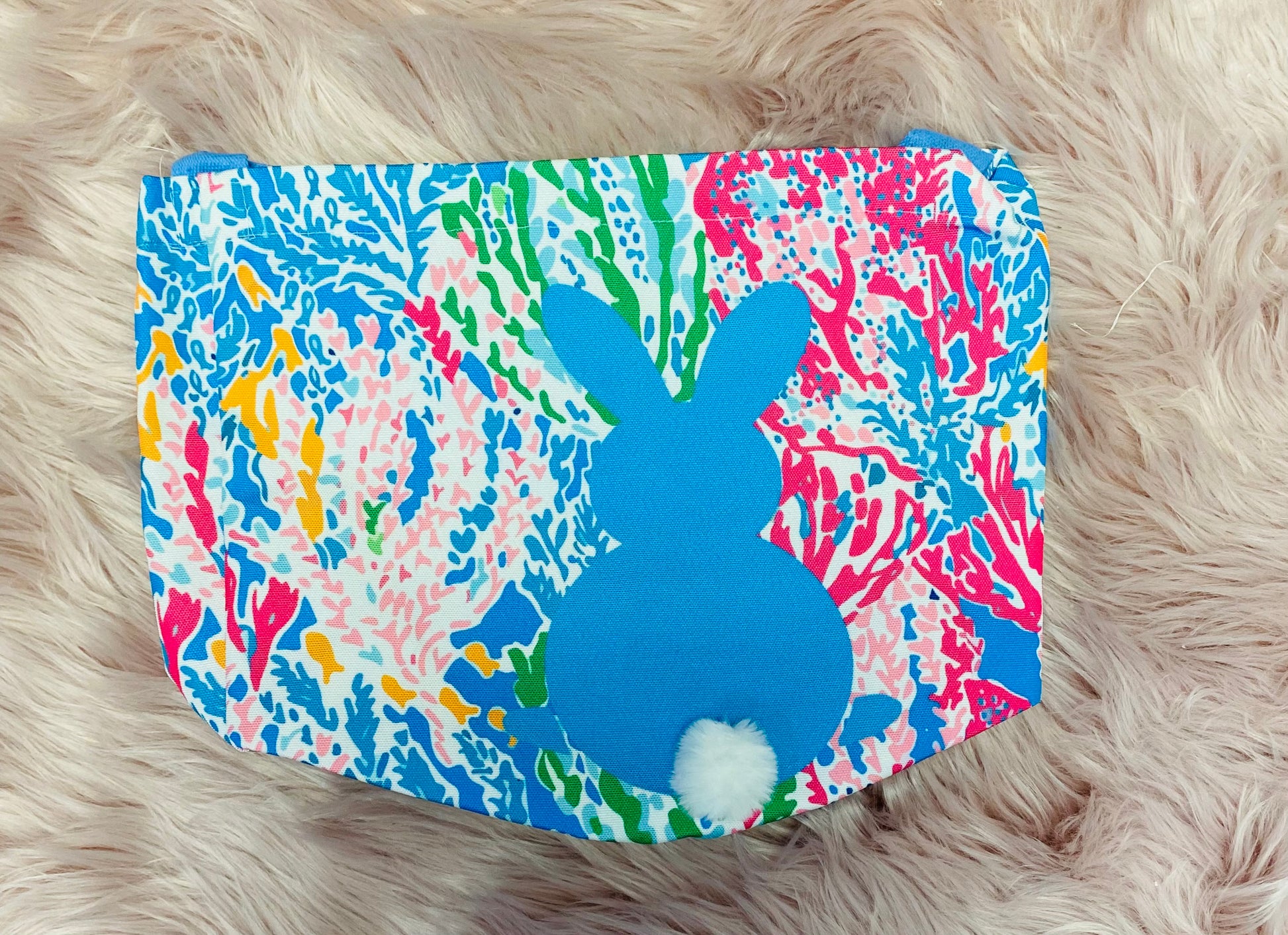 Blue Floral  personalized canvas Easter basket with glitter vinyl lettering, featuring a bunny silhouette with cotton tail, sturdy handle and a spacious design, perfect for Easter egg hunts and gifts. 