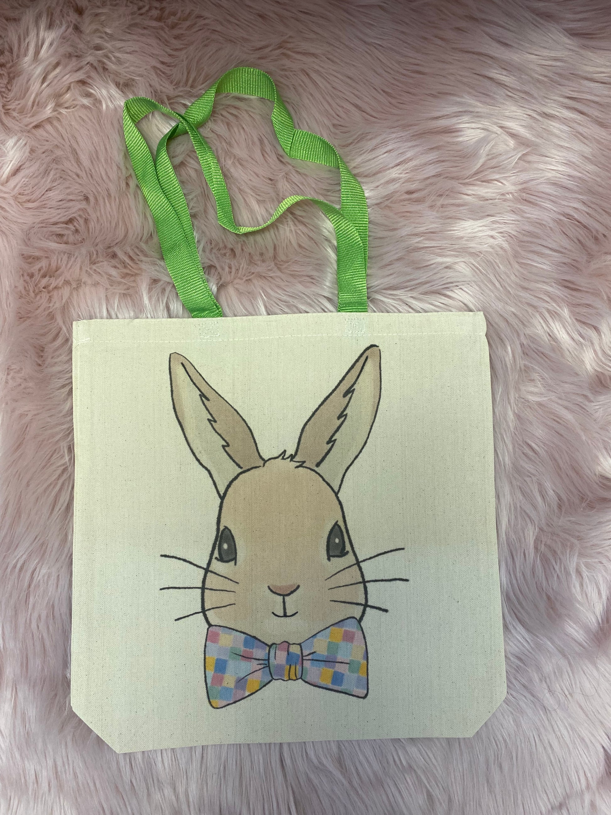 A canvas tote bag featuring a cute Easter Bunny with a bow tie, made from durable, eco-friendly material, perfect for carrying Easter gifts, eggs, and everyday essentials.